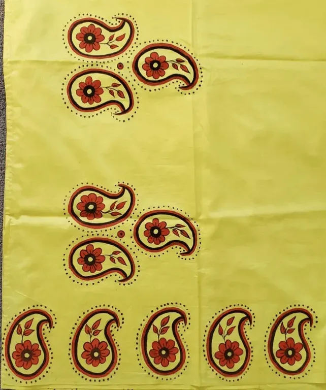 Fabric painting of red and green paisley motifs on yellow cloth