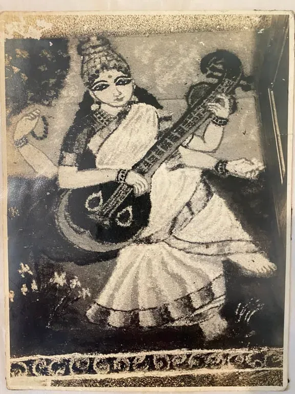 Black-and-white photograph of a rangoli of Saraswathi seated with a veena