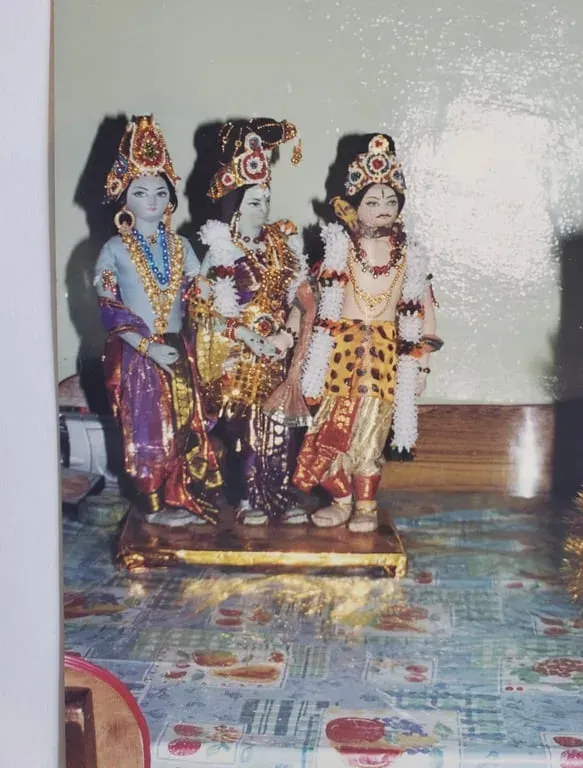Three standing dolls in crowns and jewelled costumes, an older photograph from the Ramayana series