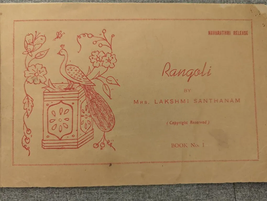 Cover of Rangoli by Mrs. Lakshmi Santhanam, Book No. 1, with a peacock drawn in red