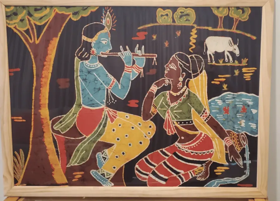 Batik of Krishna playing the flute to Radha under a tree