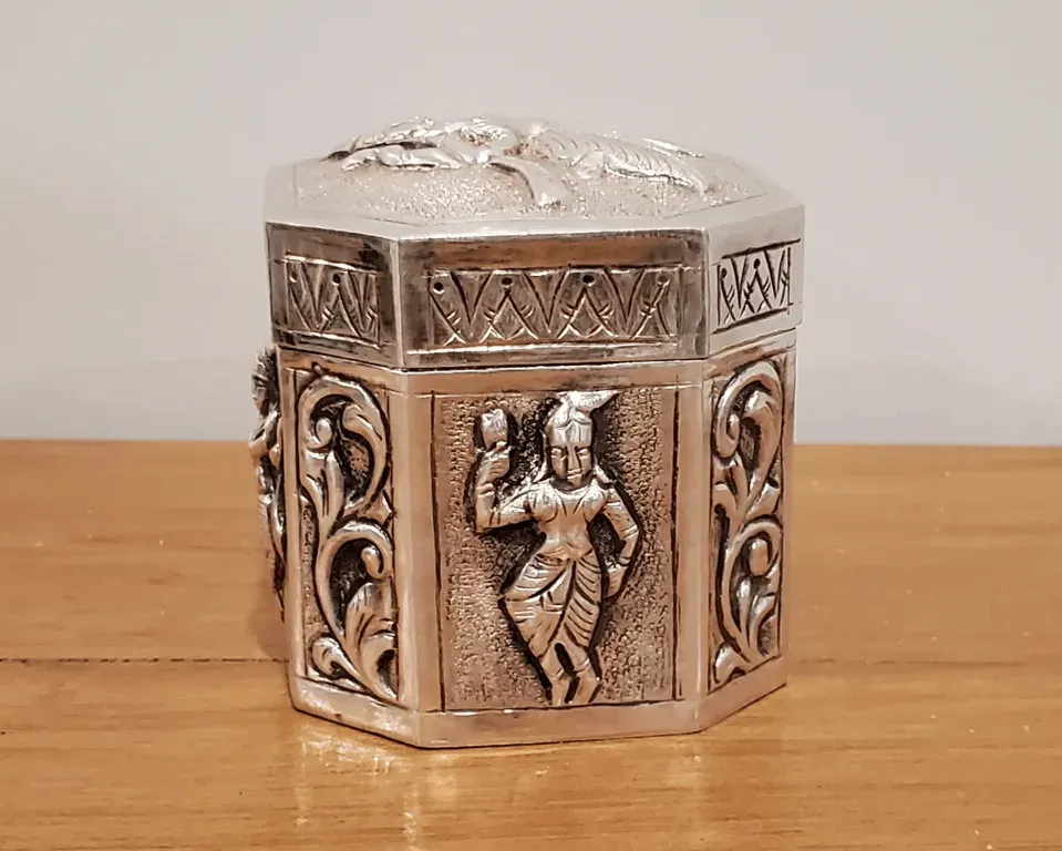 A small octagonal silver box embossed with dancing figures, a gift from her students