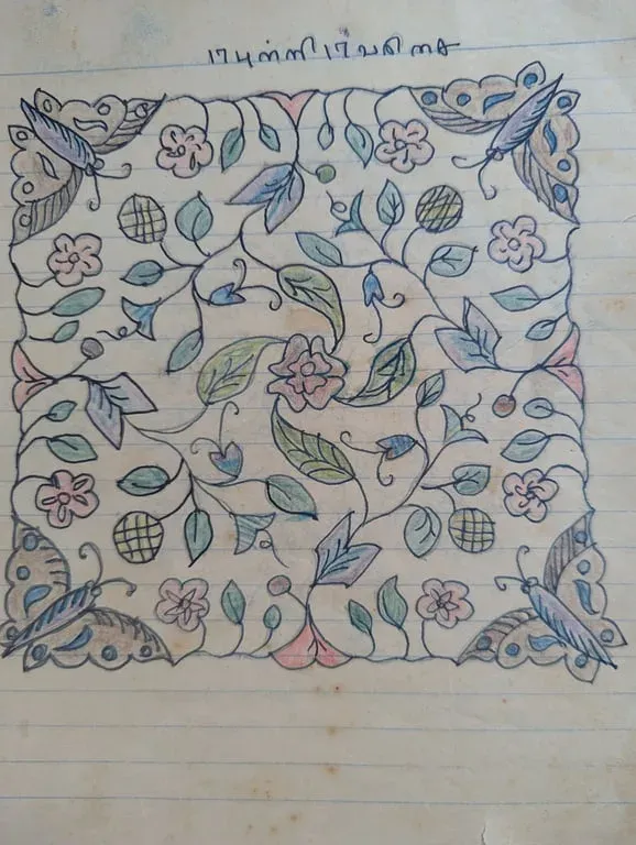 Coloured pencil kolam of vines, flowers and butterflies on a ruled notebook page