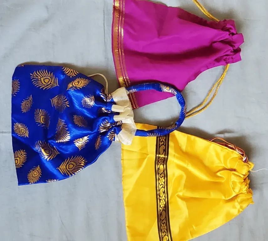 Three drawstring pouches in blue, magenta and yellow satin with gold trim