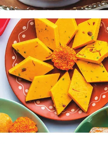 Diamond-cut badam barfi arranged in a flower pattern on a plate